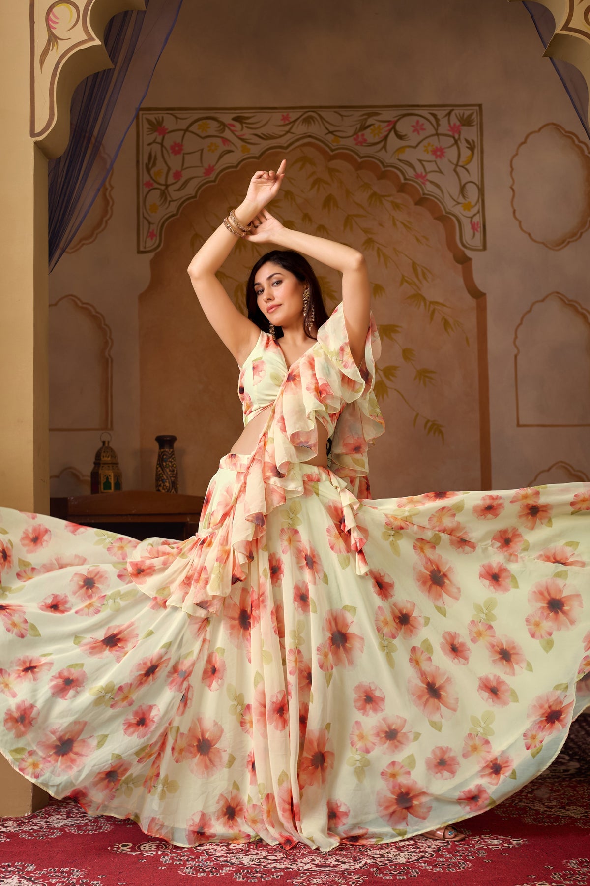 Woman in a floral dress posing in an ornate room.