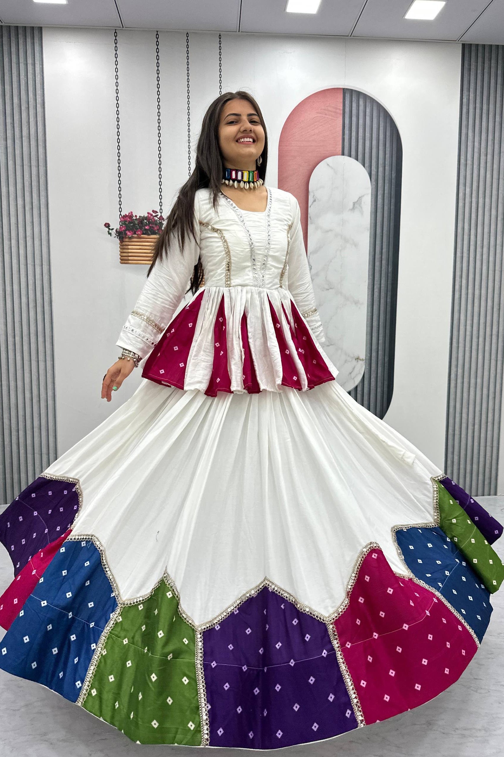 Woman wearing a colorful traditional outfit with a white background