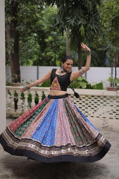 Woman in traditional outfit with a colorful skirt dancing outdoors.