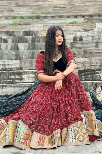 Woman in traditional outfit sitting on stone steps