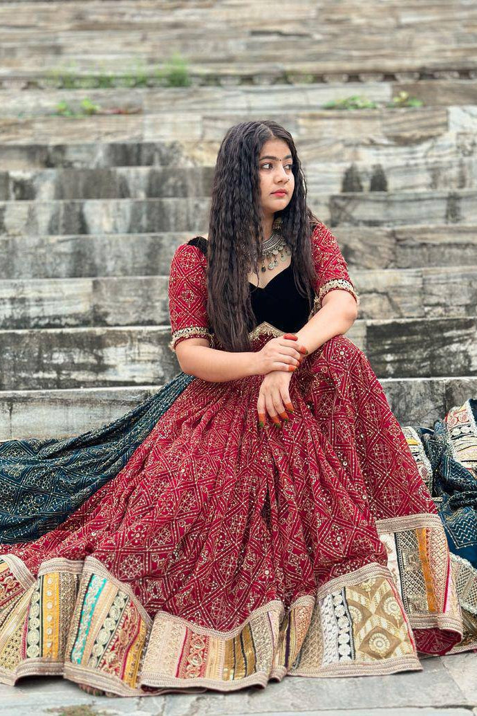 Woman in traditional outfit sitting on stone steps